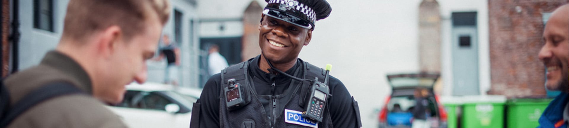 SYP police officer smiling at another person